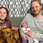 Tapestry family holds infant shortly after birth
